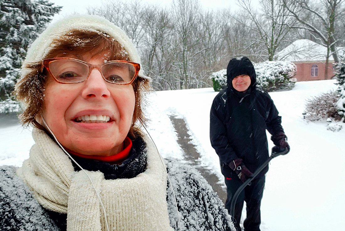 Woman and man shoveling in the wintertime